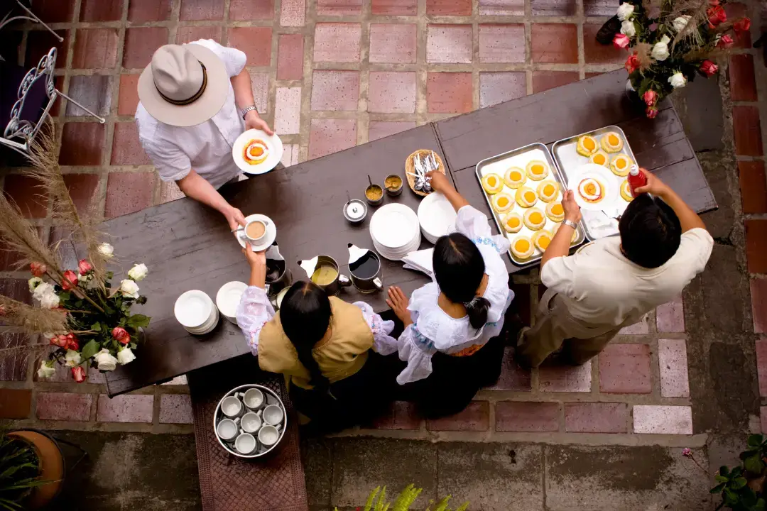 People serving food at an outdoor event.