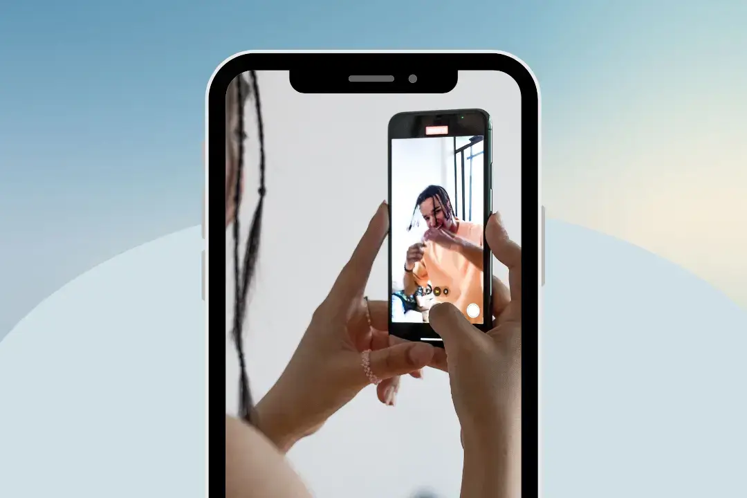 Person recording video on smartphone screen.