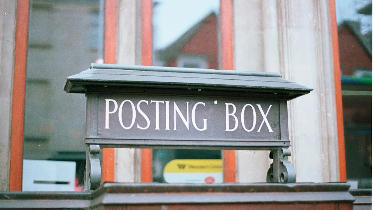 Metal posting box sign outside building