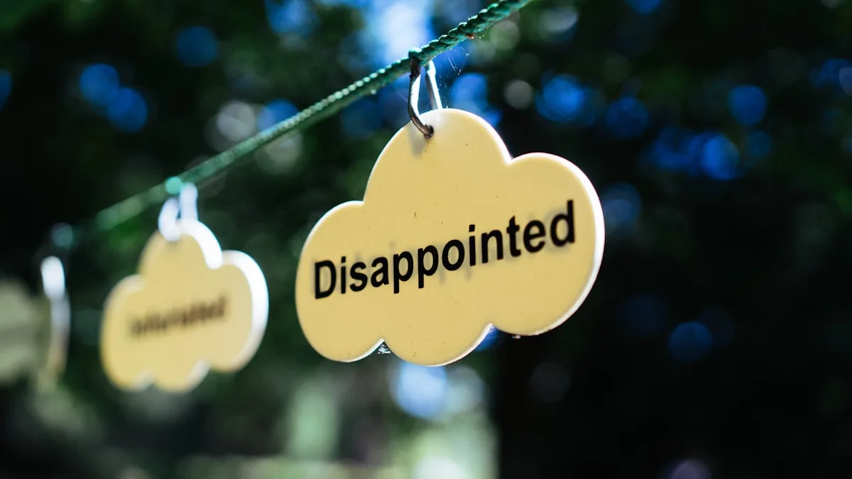 Cloud-shaped sign reading Disappointed hanging outdoors