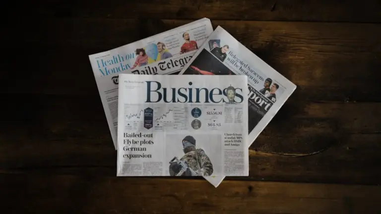 Stack of newspapers on wooden table